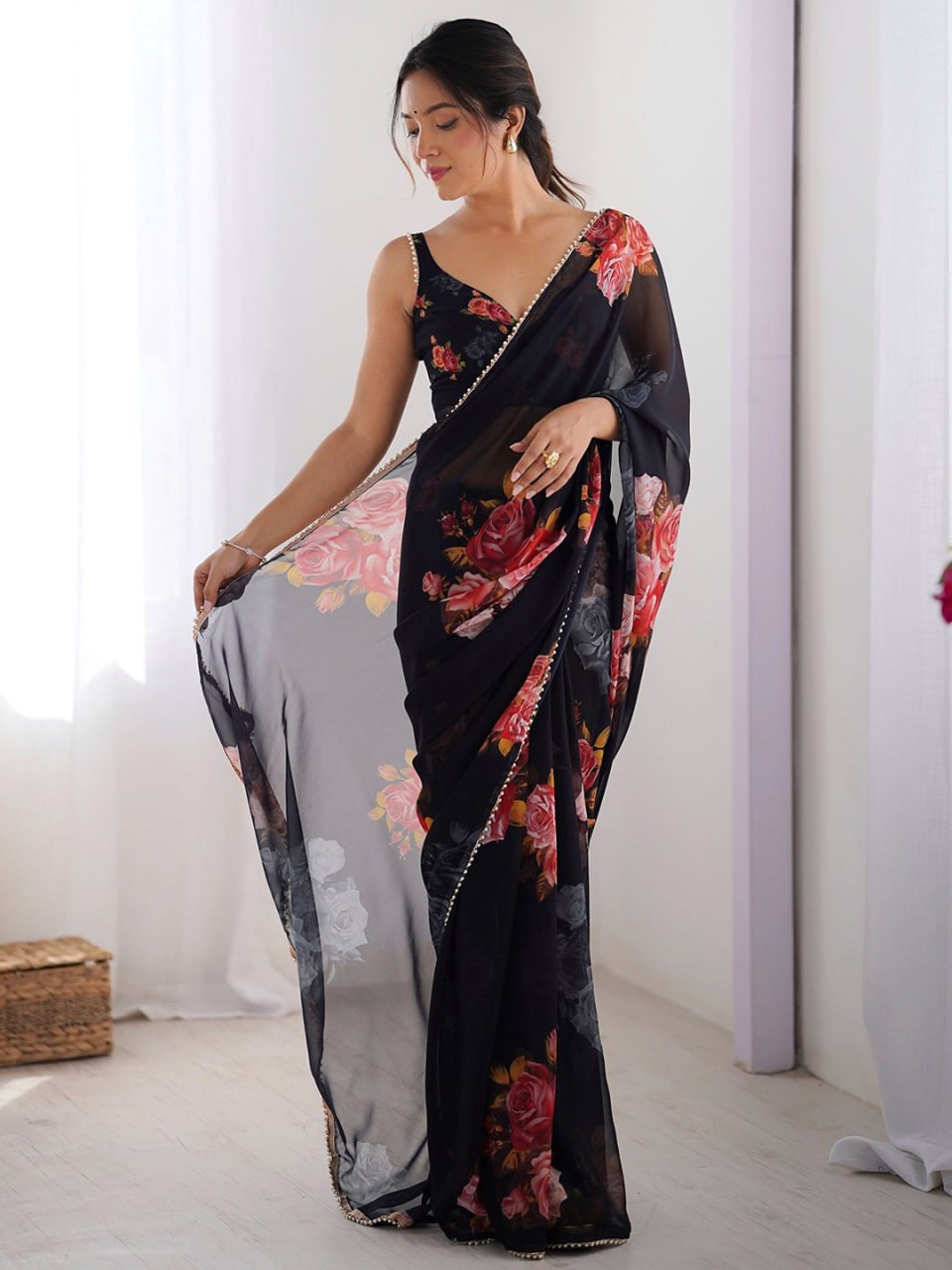 Black georgette saree with floral print and pearl border