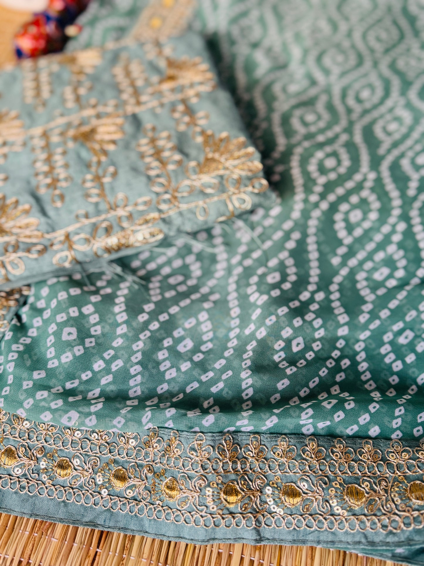 Green georgette saree in bandhini with embellished border