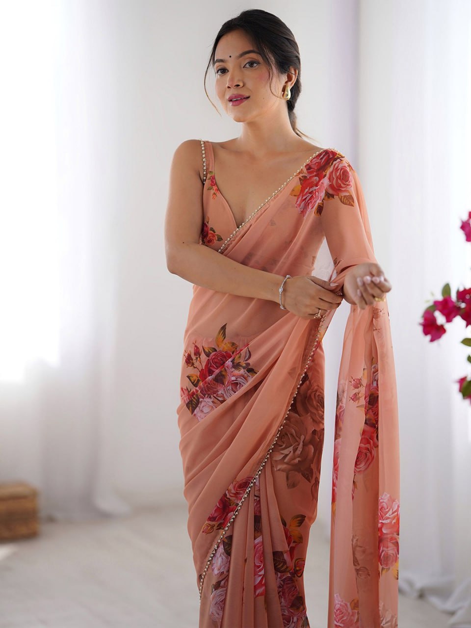 Peach georgette saree with floral print and pearl border