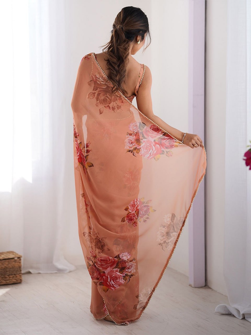 Peach georgette saree with floral print and pearl border